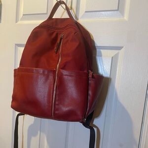 Tutilo Synthetic leather & Nylon Red padded Backpack gold tone hardwares .